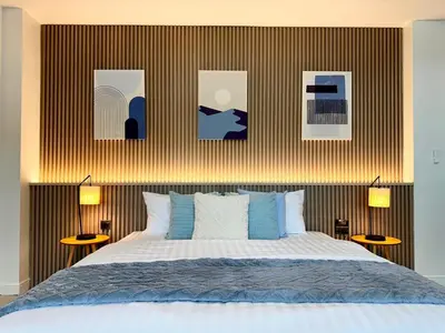 a bedroom with a bed and some pictures on the wall at Indigo Studio 2 mins from SRT Wat Samien Nari in Bangkok