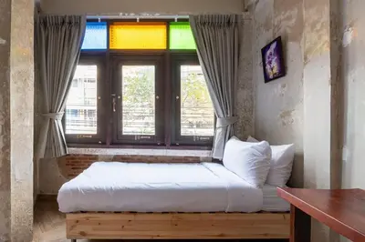 a bedroom with a bed with a window with a rainbow at Sao Chingcha Near Khao San Road MRT 3 bathtub in Bangkok