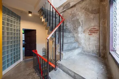 a staircase in a building with a red railing at Sao Chingcha Near Khao San Road MRT 3 bathtub in Bangkok