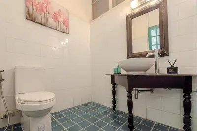 a bathroom with a toilet and a sink and a mirror at Sukumvit Pool Villa 5BR 5-7min-walk to Thonglor Sky train in Khlong Toei