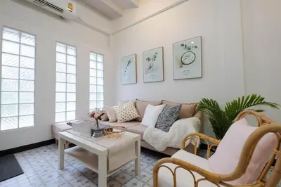 a living room with a couch and a table at HOME175 Peaceful 2BR near BTS & IconSiam in Bangkok