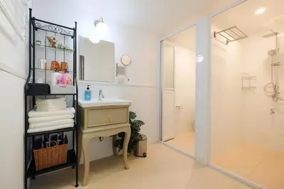 a bathroom with a shower and a sink and a mirror at HOME175 Peaceful 2BR near BTS & IconSiam in Bangkok