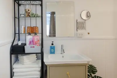 a bathroom with a sink and a shelf with towels at HOME175 Peaceful 2BR near BTS & IconSiam in Bangkok