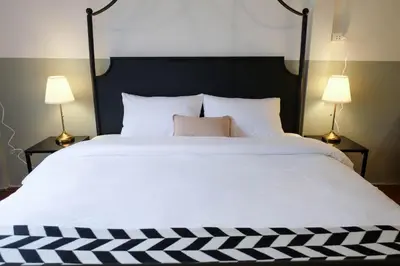 a large bed with white sheets and two lamps at HOME175 Peaceful 2BR near BTS & IconSiam in Bangkok