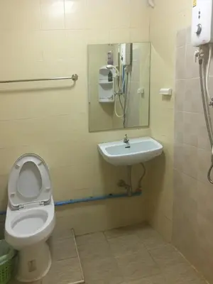 a bathroom with a toilet and a sink at Stay Hostel in Bangkok