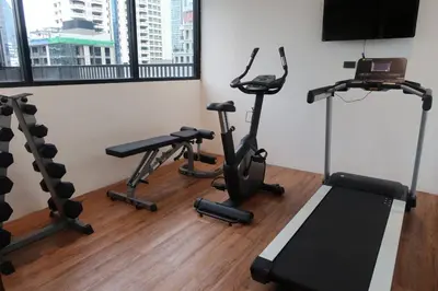 a fitness room with treadmills and tread machines at Syama Suite Sukhumvit 20 in Bangkok