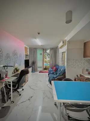 a living room with a couch and a table at Condo In Bangkok With Pool and Garden in Sathani Ban Hua Mak
