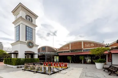 a large building with a clock tower in front of it at XX GO INN Asiatique Bangkok - โกอินน์ เอเชียทีค เจริญกรุง in Bangkok