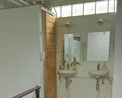 a bathroom with two sinks and a mirror at Casita Hostel House Bangkok in Bangkok