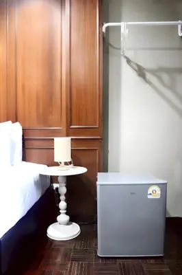 a bedroom with a bed and a nightstand next to a table at XX Stay On Sukhumvit Soi 11 BTS Nana Pro in Makkasan