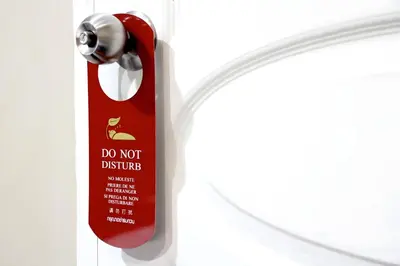 a red doorhandle with a do not disturb sign on it at XX Stay On Sukhumvit Soi 11 BTS Nana Pro in Makkasan