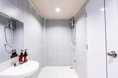 a bathroom with a shower and a sink at XX Stay On Sukhumvit Soi 11 BTS Nana Pro in Makkasan