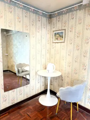 a room with a table and chairs and a mirror at XX Stay On Sukhumvit Soi 11 BTS Nana Pro in Makkasan
