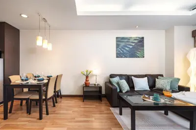 a living room with a couch and a table at Verdant Vista King Suite near BTS with Modern Amenities in Khlong Toei