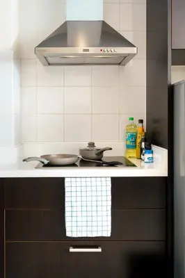 a kitchen with a stove and a stove top oven at Mystic Haven King Bed Suite with Balcony & City Views in Khlong Toei