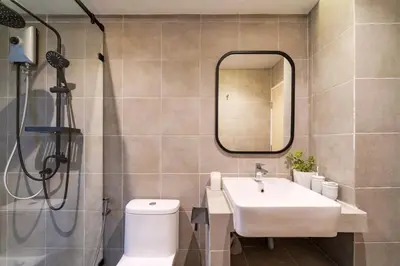 a bathroom with a sink and a toilet and a mirror at Bathtub, 2BR, 2BA, 120 Sqm, 6 Pax, Near BTS 7-11 in Bangkok
