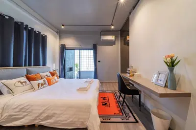 a bedroom with a large bed and a desk at Bathtub, 2BR, 2BA, 120 Sqm, 6 Pax, Near BTS 7-11 in Bangkok