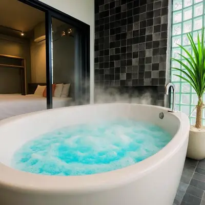 a bath tub filled with blue water in a bathroom at Bathtub, 2BR, 2BA, 120 Sqm, 6 Pax, Near BTS 7-11 in Bangkok