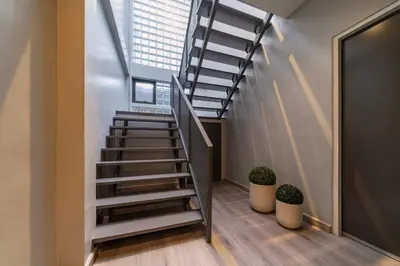 a spiral staircase in a room with a window at Bathtub, 2BR, 2BA, 120 Sqm, 6 Pax, Near BTS 7-11 in Bangkok