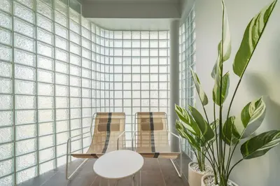 two chairs and a table in a room with a plant at Bathtub, 2BR, 2BA, 120 Sqm, 6 Pax, Near BTS 7-11 in Bangkok