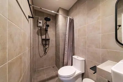 a bathroom with a toilet and a shower and a sink at Bathtub, 2BR, 2BA, 120 Sqm, 6 Pax, Near BTS 7-11 in Bangkok