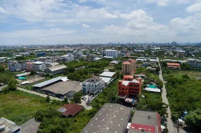 an aerial view of a city with buildings and trees at Thongtara House Boutique Srinakarin in Bangkok