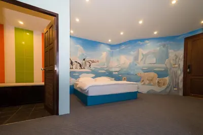 a bedroom with a painting on the wall at Thongtara House Boutique Srinakarin in Bangkok