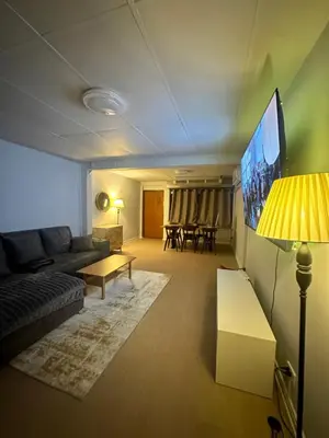 a living room with a couch and a flat screen tv at Mango Hostel - 420 Friendly in Bangkok
