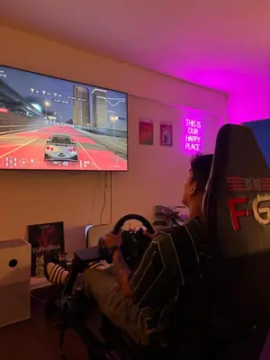 a man is playing a video game on a tv at Mango Hostel - 420 Friendly in Bangkok