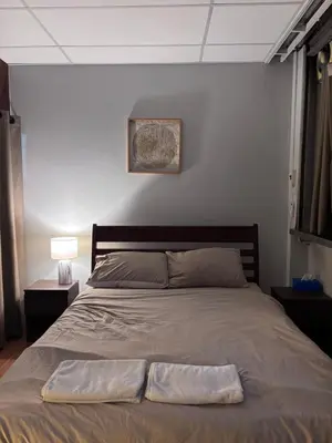 a bedroom with a large bed with aasser at Mango Hostel - 420 Friendly in Bangkok