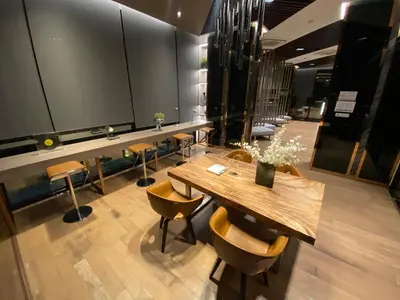 a conference room with a wooden table and chairs at 2BR Condo with Oldtown Bangkok Vibes, Steps from Wongwian Yai in Bangkok