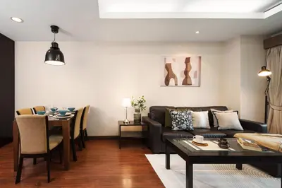 a living room with a couch and a table at King-Suite with Balcony and a full Kitchen near ThonglorBTS in Khlong Toei