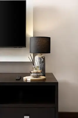 a lamp on top of a table in a room at King-Suite with Balcony and a full Kitchen near ThonglorBTS in Khlong Toei