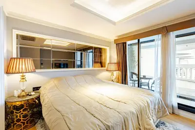 a bedroom with a large bed and a balcony at State tower City view Central River Station in Bangkok