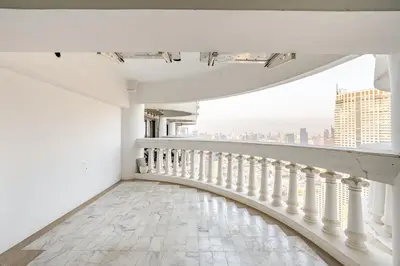 a white balcony with a view of the city at State tower City view Central River Station in Bangkok