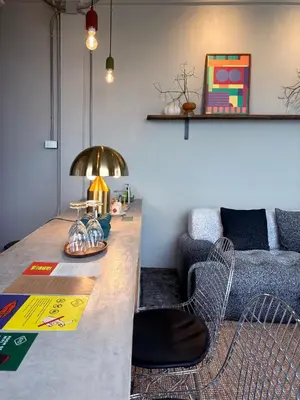 a living room with a table and a couch at Citrus House Phra-Arthit in Bangkok