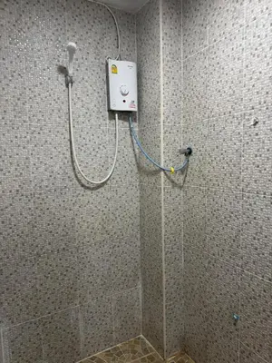 a shower in a bathroom with a shower at WannaB Hostel in Khlong San