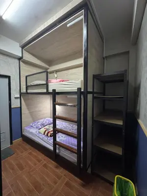 a couple of bunk beds in a room at WannaB Hostel in Khlong San