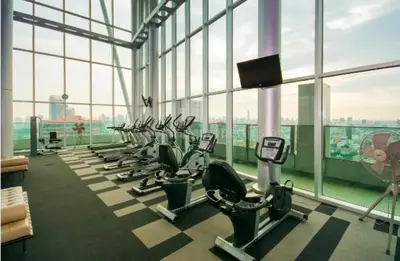 a gym with a row of treadmills and machines at 2BR 2BA Luxury Lifestyle 5min walk Thonglor BTS in Bangkok