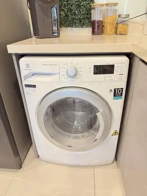a white washing machine with a counter above it at 2BR 2BA Luxury Lifestyle 5min walk Thonglor BTS in Bangkok