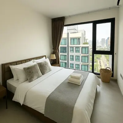 a bedroom with a large white bed with a large window at 2BR 2BA Luxury Lifestyle 5min walk Thonglor BTS in Bangkok