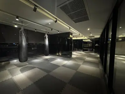 a gym with two boxing bags hanging from the wall at River Cando Perfect for relaxing in Ban Sai Ma