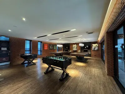 a room with two pool tables and a ping pong table at River Cando Perfect for relaxing in Ban Sai Ma