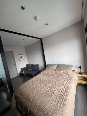 a bedroom with a large bed and a chair at River Cando Perfect for relaxing in Ban Sai Ma