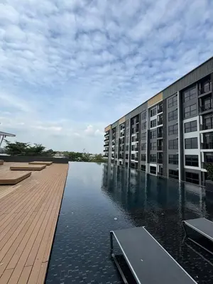 a building with a body of water next to a building at River Cando Perfect for relaxing in Ban Sai Ma