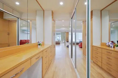 a kitchen with wooden cabinets and glass walls at Bangkok Japanese designed 3BR Home Ekkamai BTS in Bangkok