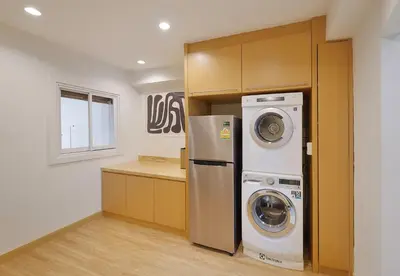a kitchen with a washer and dryer in a room at Bangkok Japanese designed 3BR Home Ekkamai BTS in Bangkok
