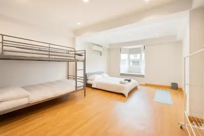 a bedroom with two bunk beds and a couch at Bangkok Japanese designed 3BR Home Ekkamai BTS in Bangkok