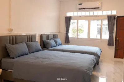 two beds sitting next to each other in a bedroom at Nan Square II in Bangkok