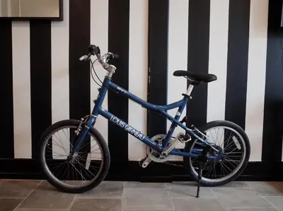 a blue bike parked in front of a wall at Stylist Siamese Design House Steps To Chinatown - Self Check In in Bangkok